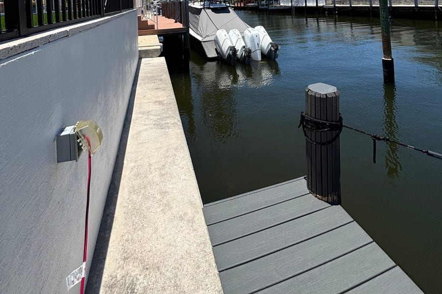 Sportfish boat with a tower tied up along a seawall on a South Florida canal