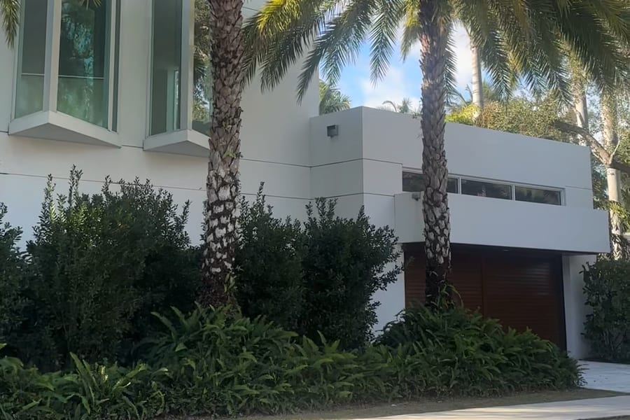 Modern white home behind mature palms on a Rio Vista street, Fort Lauderdale