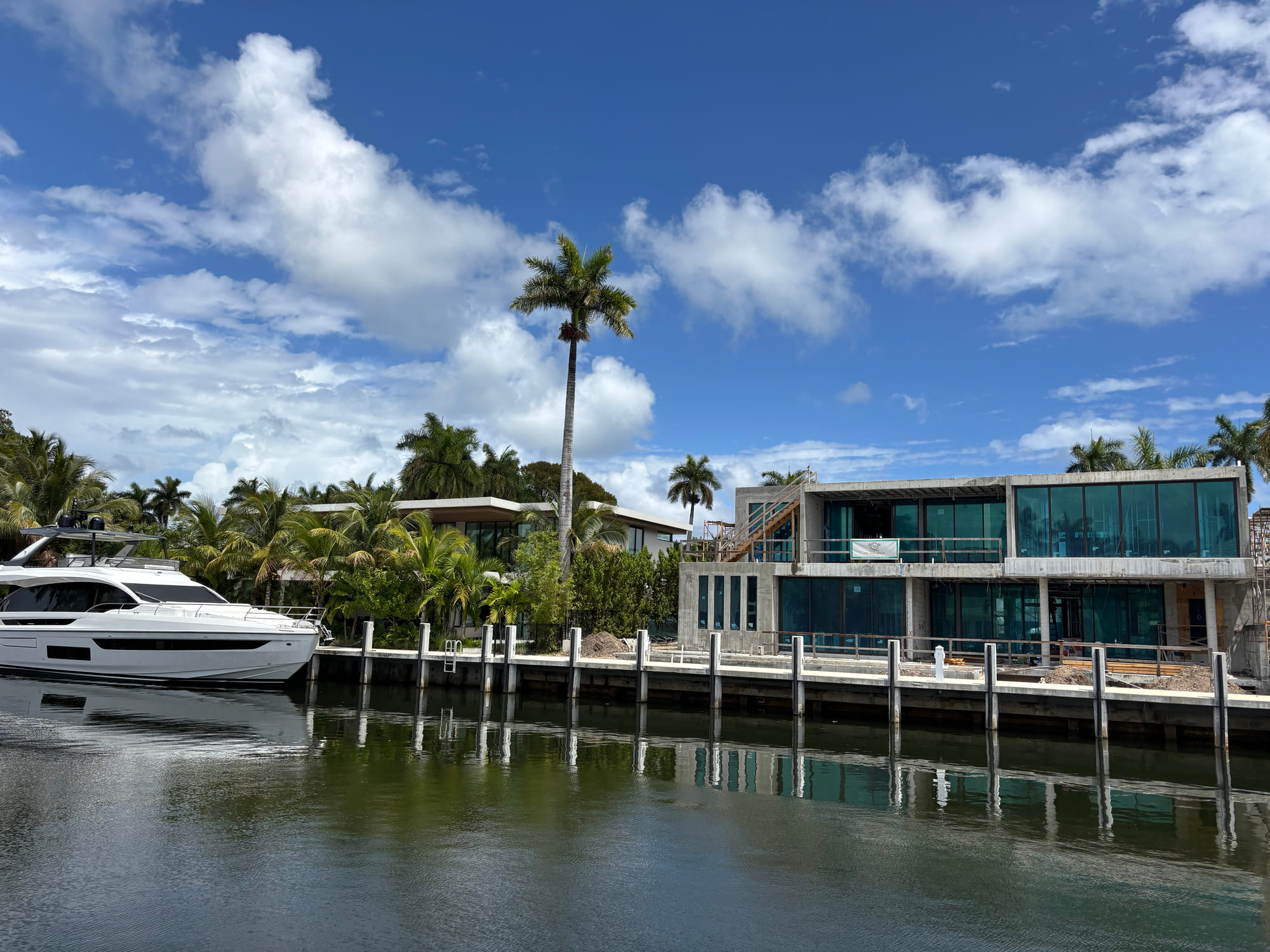Motor yacht docked behind a modern waterfront home on a Fort Lauderdale canal