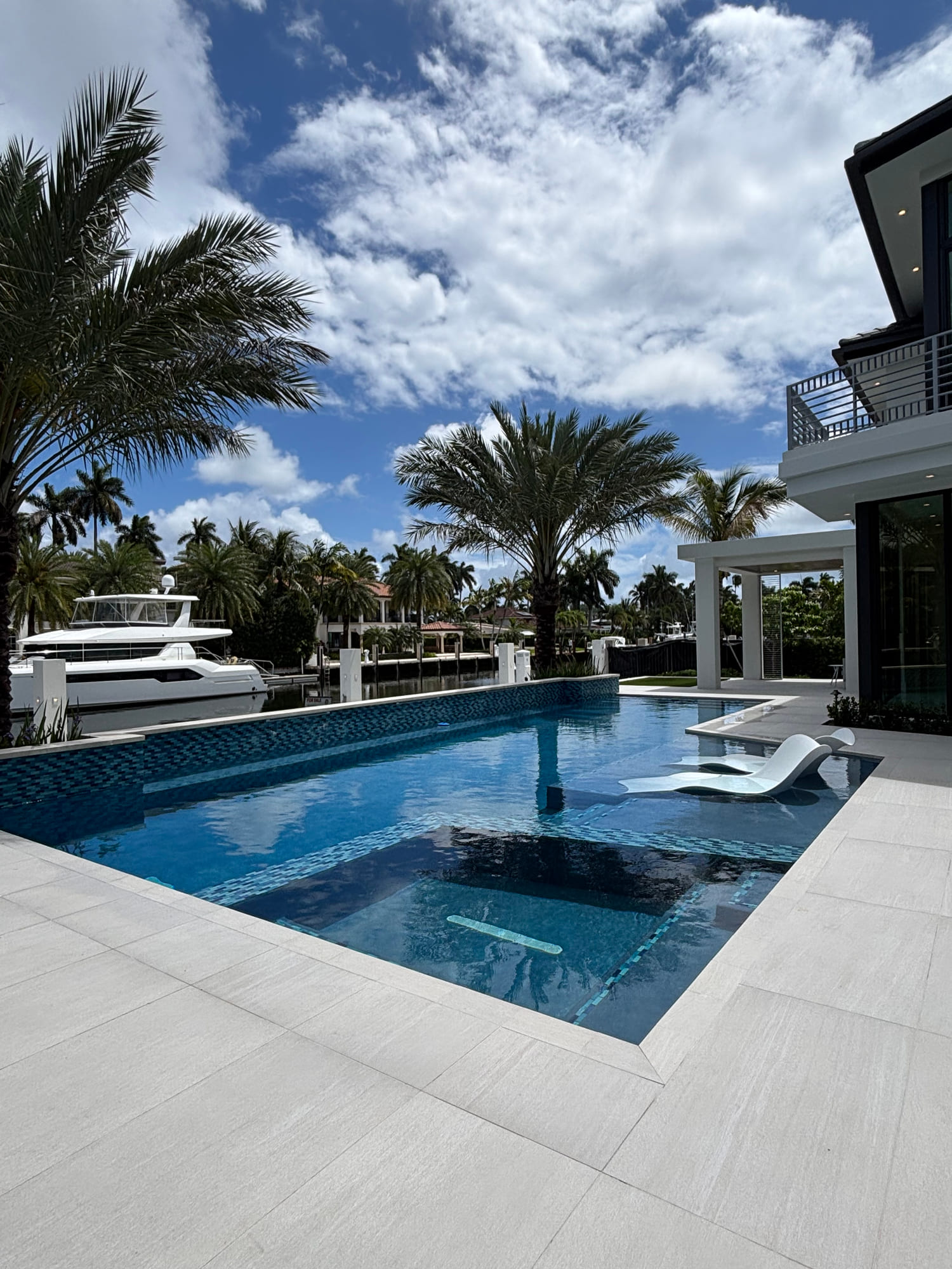 Pool deck and waterfront view at a South Florida canal home
