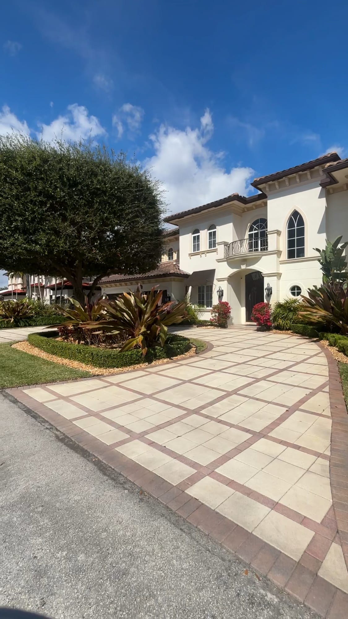 Mediterranean style estate with a paver driveway in Coral Ridge, Fort Lauderdale